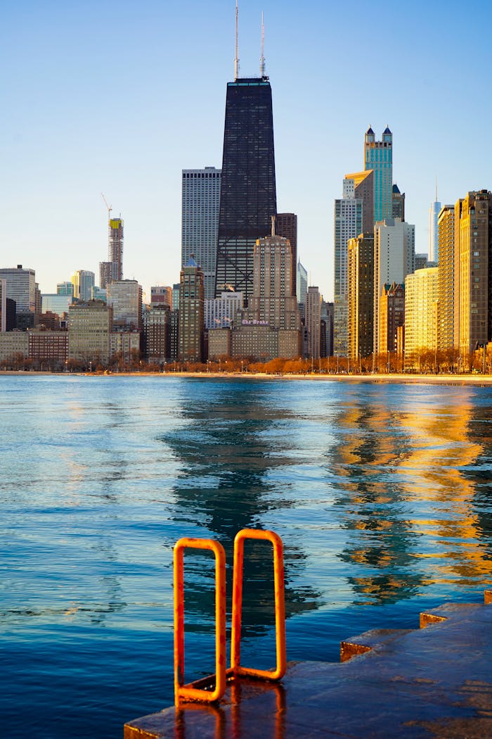 A stunning view of the Chicago skyline reflecting in the water during daylight.