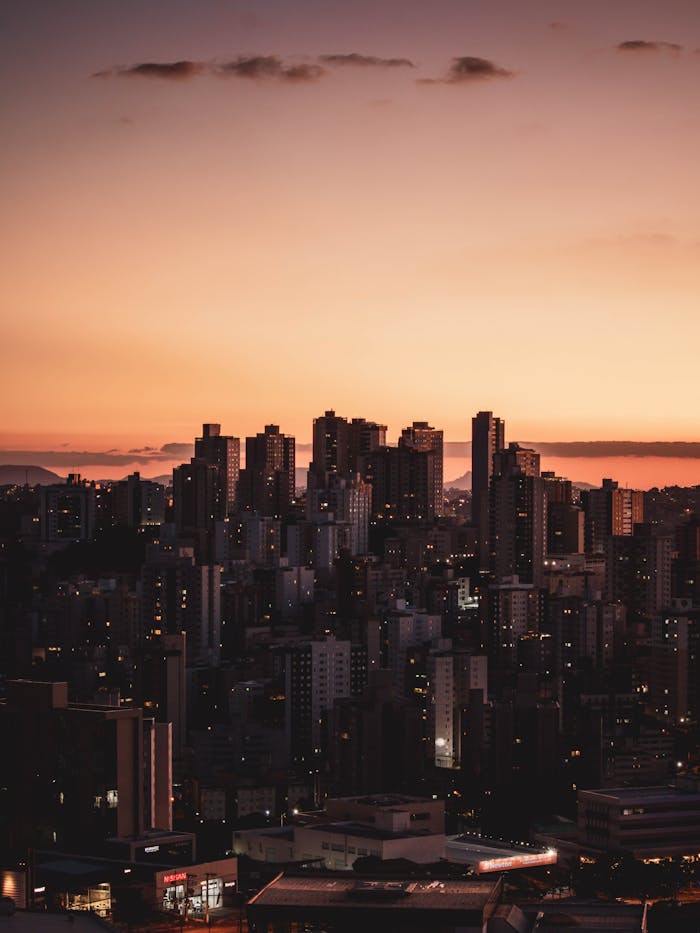 Captivating sunset over Belo Horizonte's skyline, highlighting high-rise urban landscape.